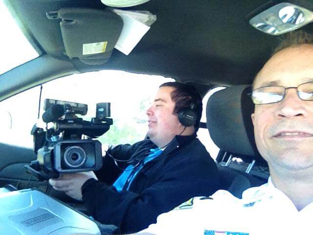 Ryan French Tampa Bay Cameraman videographer in a deputy's cruiser